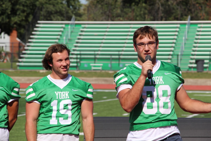 Varsity captain Sam Varzino speaks to students at the pep rally about the upcoming game. 