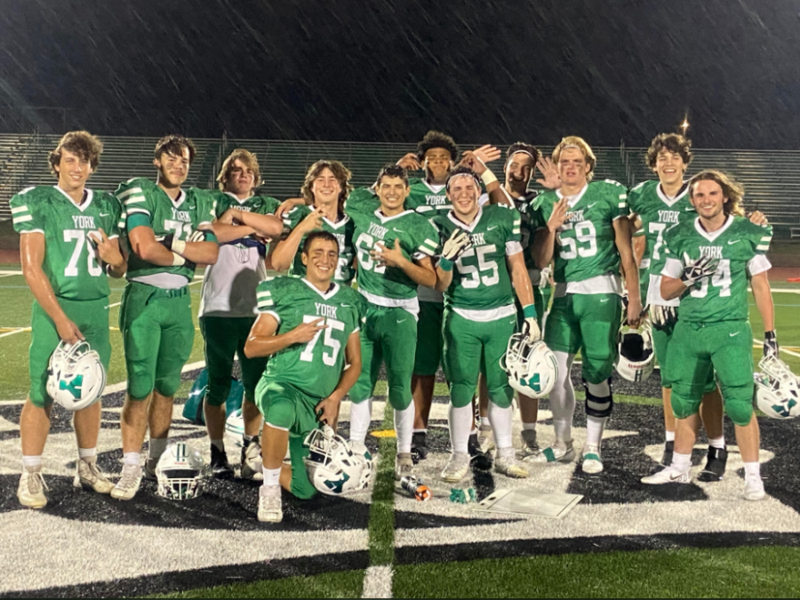 Members of the varsity football team pose after defeating Lyons Township. Obviously it was a huge accomplishment for the program, and something that hasnt been done in 10 years, coach Michael Fitzgerald said. Im just really proud of the kids for all the hard work they put in to get us back to a winning program.