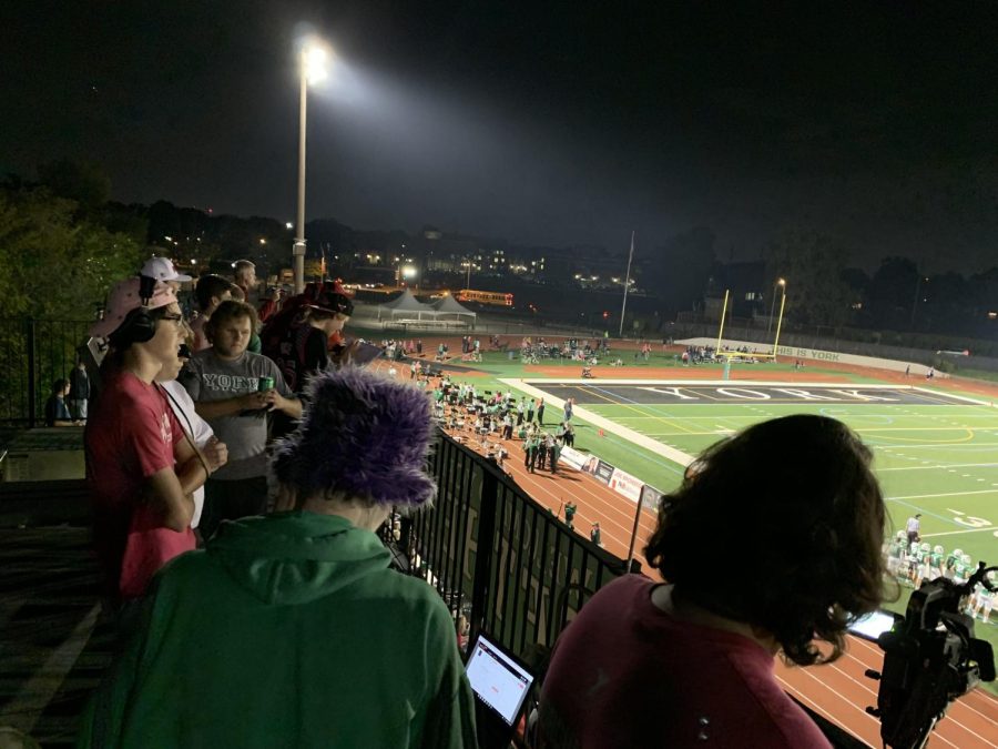 Members of York Sports Network broadcast the varsity football game against Hinsdale Central from the press box at the top of the stadium. (Photo by Finnegan Belleau)
