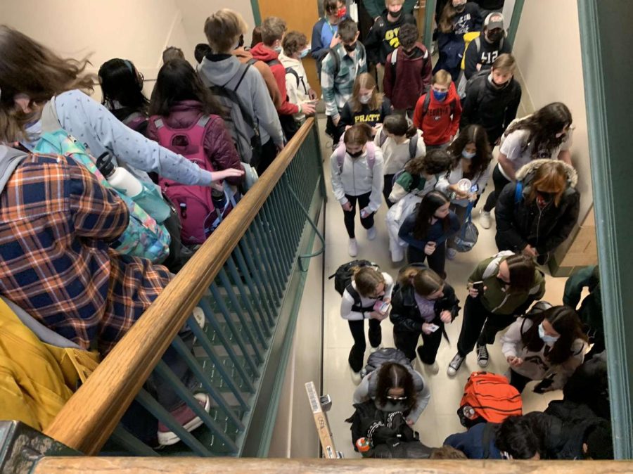 Students crowd in the hallway leading into the lunchroom waiting to approach the swipe cart.