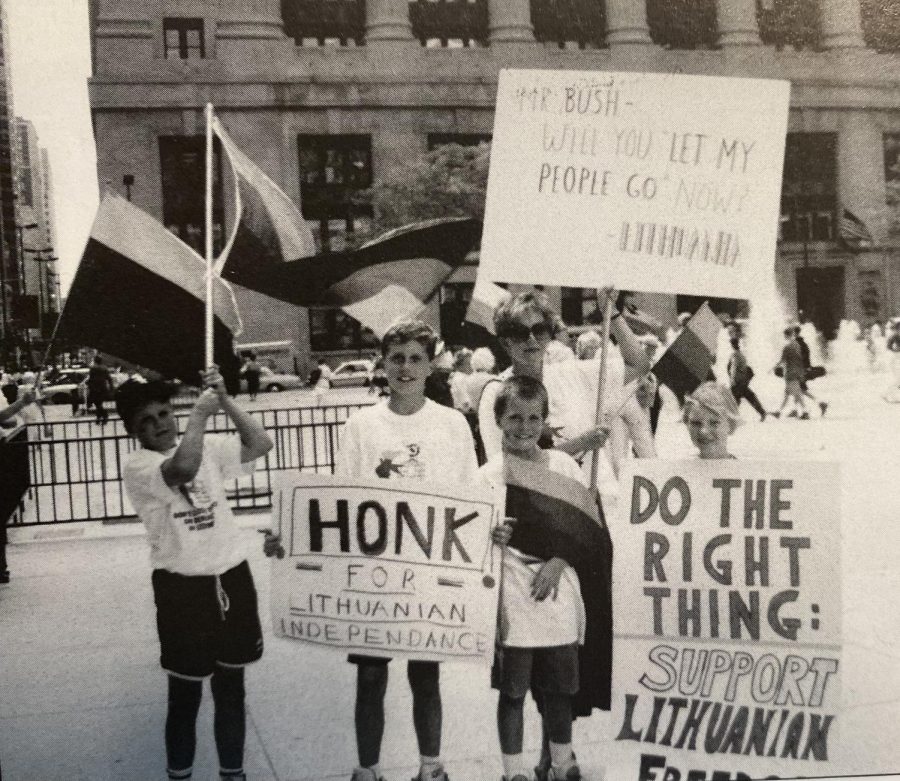 On the far left, Justin Riskus stands with the Lithuanian flag in March of 1990 at a Chicago rally to support Lithuanians strive for independence.