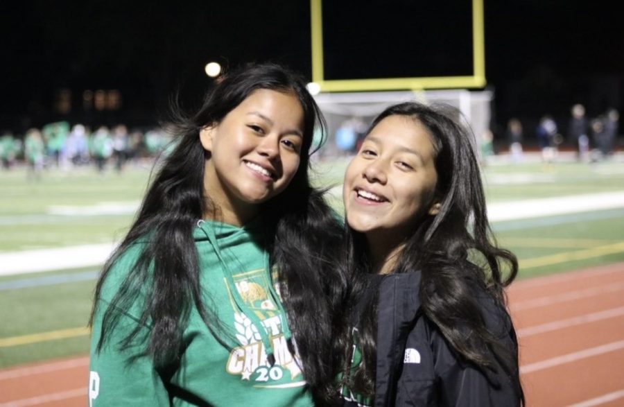 Evelyn Popoca and Sofia Malagon get a photo taken during halftime at a home game.
