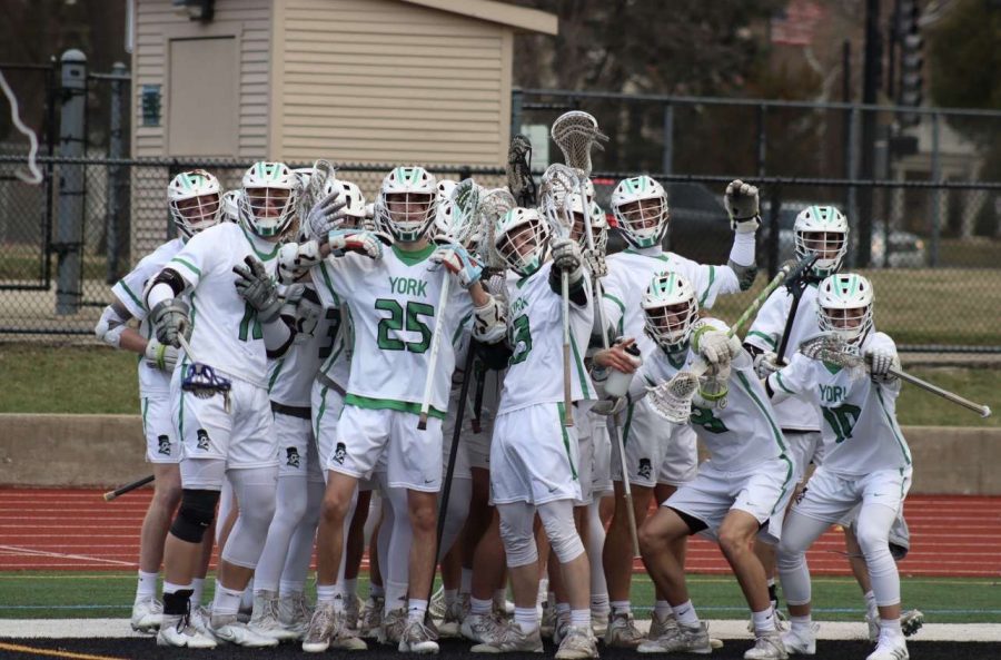 Varsity lacrosse poses together during a game. Photo courtesy of Brian Grant.