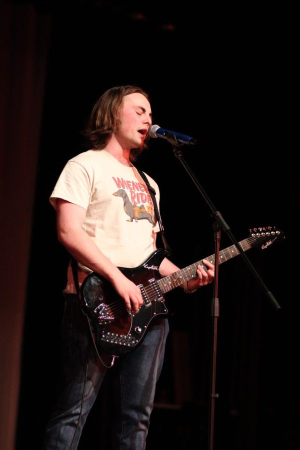 Patrick McLaughlin, senior, plays guitar and sings in one of the four acts hes in.