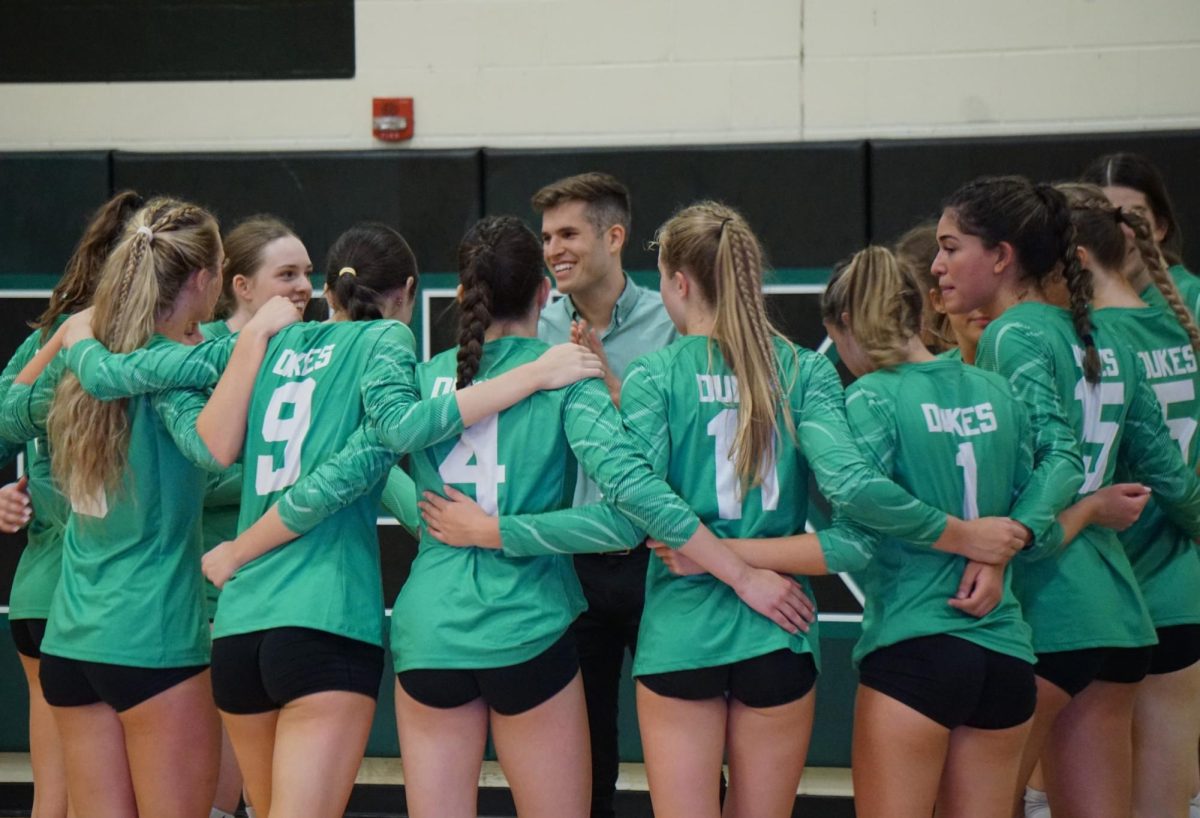 The York Girls Varsity Volleyball team joined in a huddle to discuss the next play.