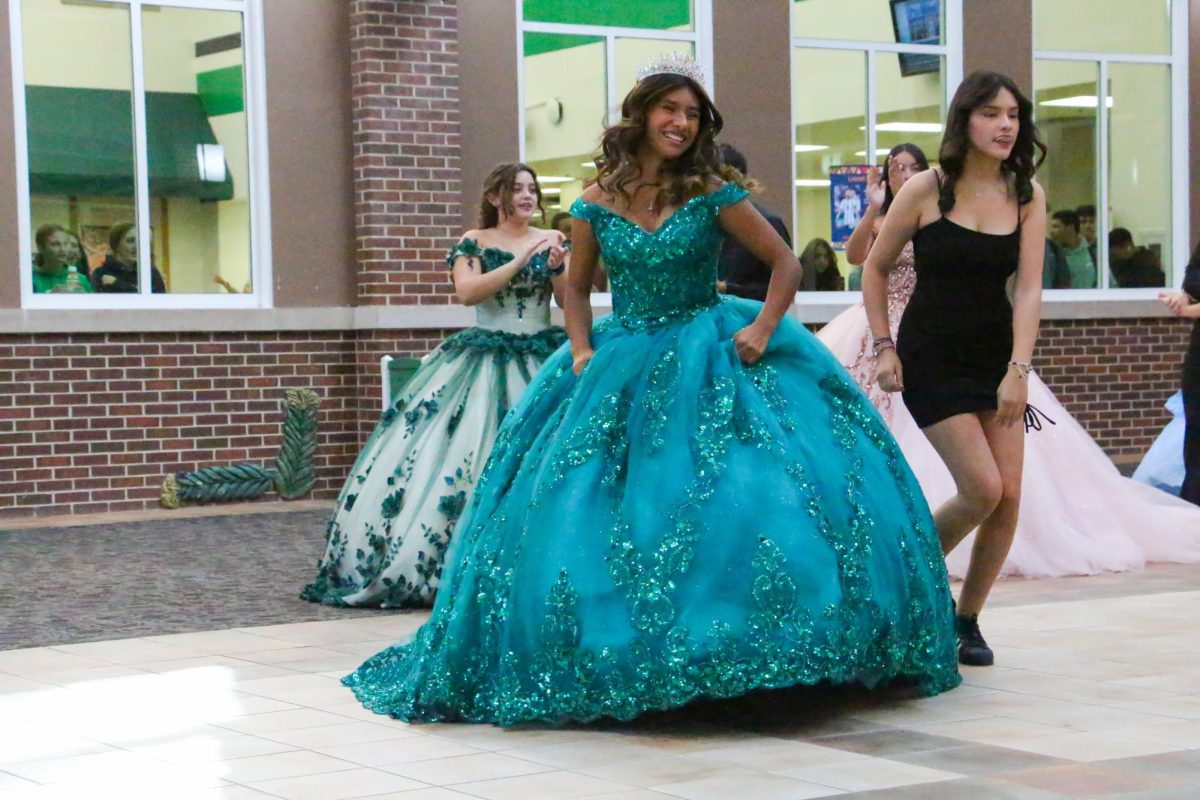 Briana Cruz, senior, makes a grand exit after the 4th period performance. "We all learn different things," Cruz said. "Showing that in Hispanic culture there is something called a quinceañera, it allows us to be a community all together by learning and by watching."