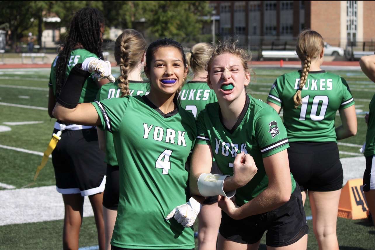 Isabella Carrera (left) and Clara Fitzer, seniors, flexing in pride during a game. 